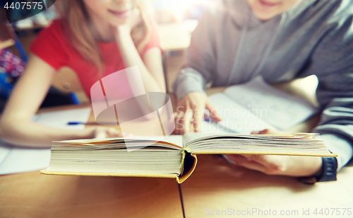 Image of high school students reading book and learning