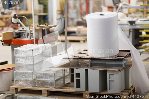 Image of roll of foam wrap at woodworking factory workshop