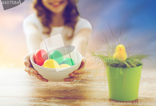 Image of close up of girl holding colored easter eggs