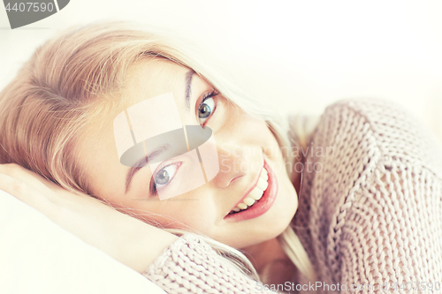 Image of young woman or teen girl lying on pillow at home