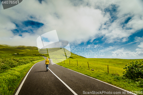 Image of Woman walking over a beautiful road