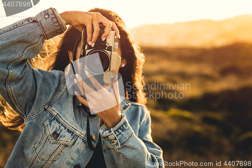 Image of Woman Taking Picture Outdoors