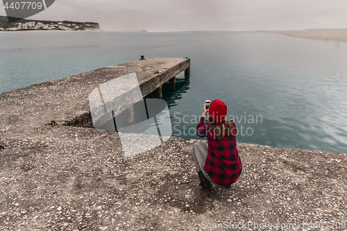 Image of Woman taking pictures with a cellphone