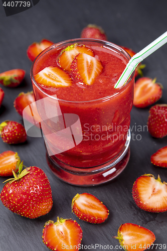 Image of Strawberry in fresh smoothie on black table