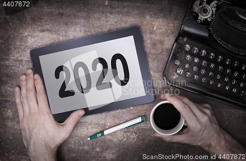 Image of Tablet touch computer gadget on wooden table - 2020