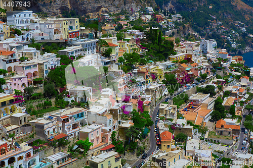 Image of One of the best resorts of Italy with old colorful villas on the steep slope, nice beach, numerous yachts and boats in harbor and medieval towers along the coast, Positano.