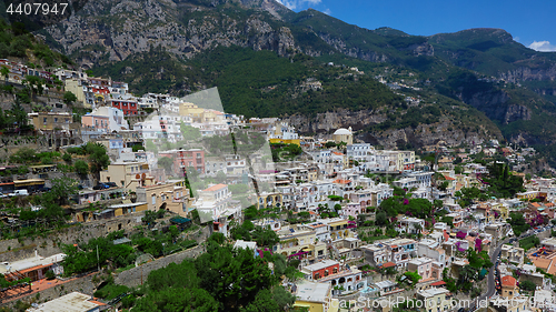 Image of One of the best resorts of Italy with old colorful villas on the steep slope, nice beach, numerous yachts and boats in harbor and medieval towers along the coast, Positano.