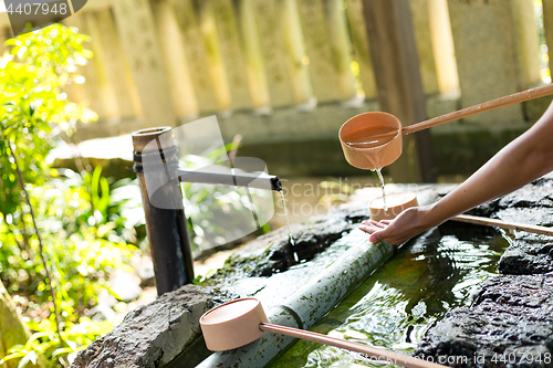 Image of Woman washing hand before go to Japanese temple