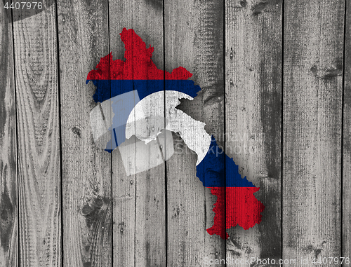 Image of Map and flag of Laos on weathered wood