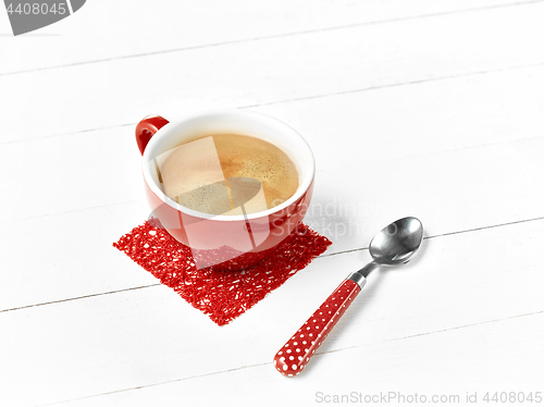 Image of red coffee cup on wood table