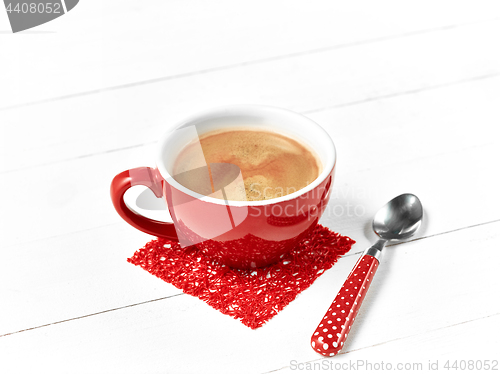 Image of red coffee cup on wood table