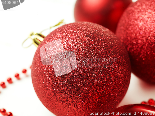 Image of three red christmas balls isolated on white background