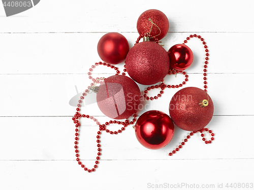 Image of three red christmas balls isolated on white background