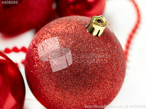 Image of three red christmas balls isolated on white background