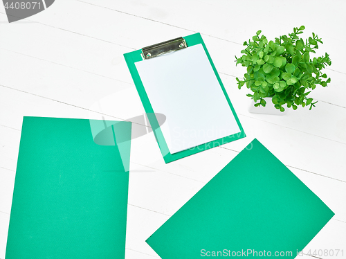 Image of Office table desk with set of colorful supplies, white blank not