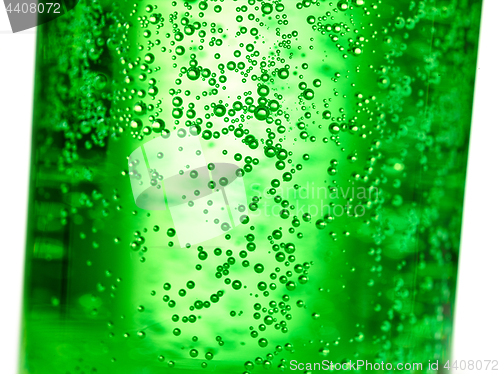 Image of abstract background : bubble of sparkling water soda on the green glass bottle with gradient light