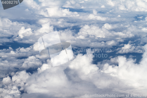 Image of Sunrise above clouds from airplane window