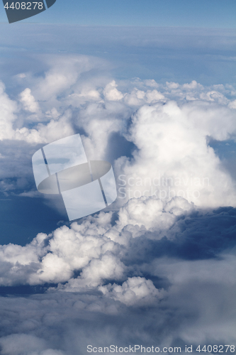 Image of Sunrise above clouds from airplane window