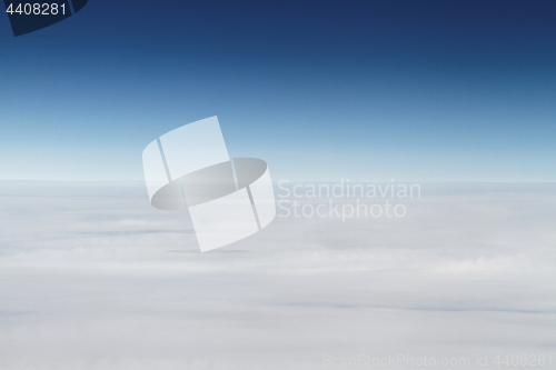 Image of Sunrise above clouds from airplane window