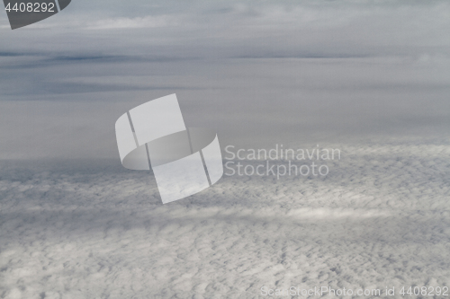 Image of Sunrise above clouds from airplane window