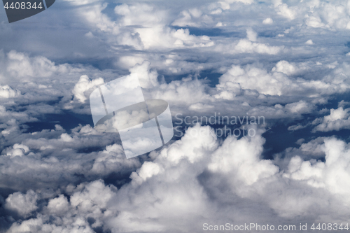 Image of Sunrise above clouds from airplane window