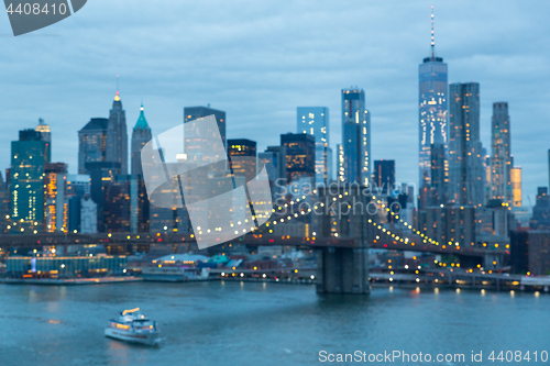 Image of Out of focus image of Brooklyn Bridge and Lower Manhattan skyline at night, New York city, USA.