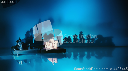 Image of Chess With Dark Shadows On A Blue Background