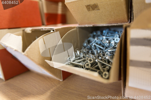 Image of screws in cardboard boxes at workshop