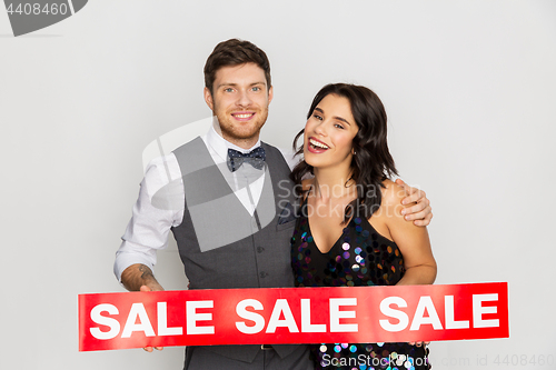 Image of happy couple with red sale sign