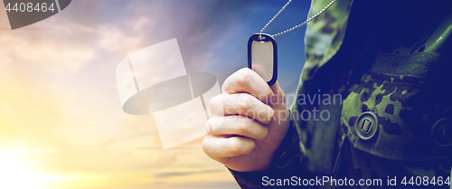 Image of close up of young soldier with military badge