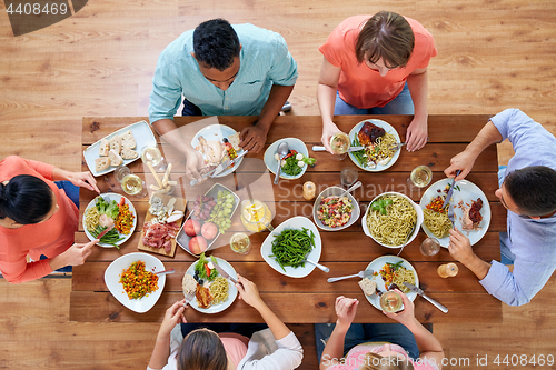 Image of group of people eating at table with food