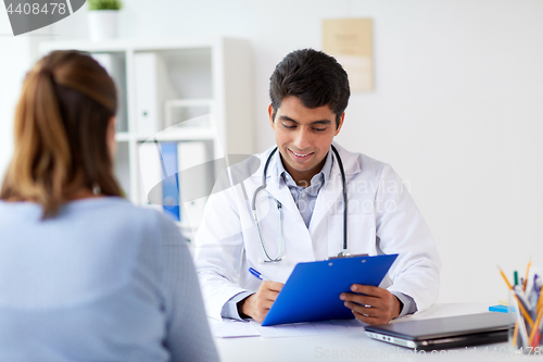 Image of doctor with clipboard and patient at hospital