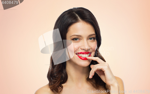 Image of beautiful smiling young woman with red lipstick