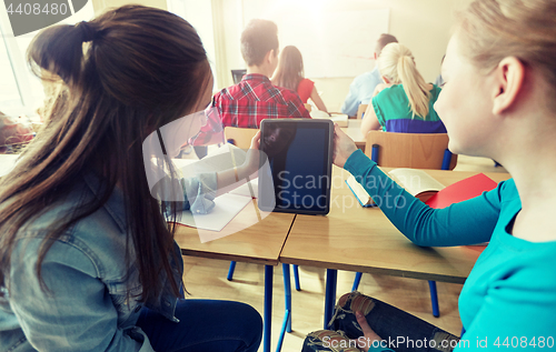 Image of happy student girls with tablet pc at high school