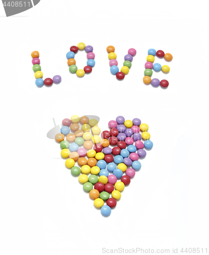 Image of Word ''Love'' and abstract heart from bright colorful candy 