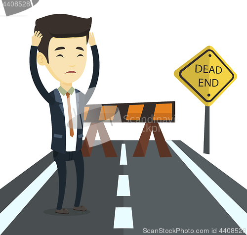 Image of Business man looking at road sign dead end.