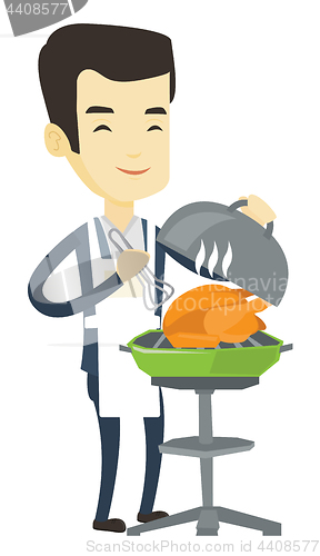 Image of Man cooking chicken on barbecue grill.