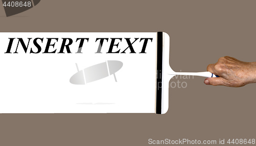 Image of an elderly woman's hand holds a scraper