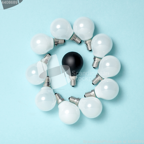 Image of One light bulb outstanding,glowing different.business creativity idea concepts.flat lay design