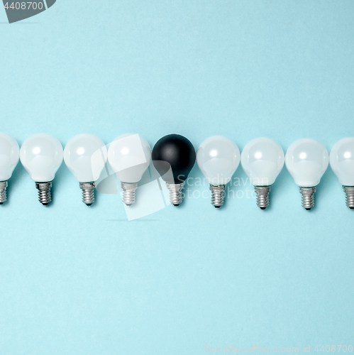 Image of One light bulb outstanding,glowing different.business creativity idea concepts.flat lay design