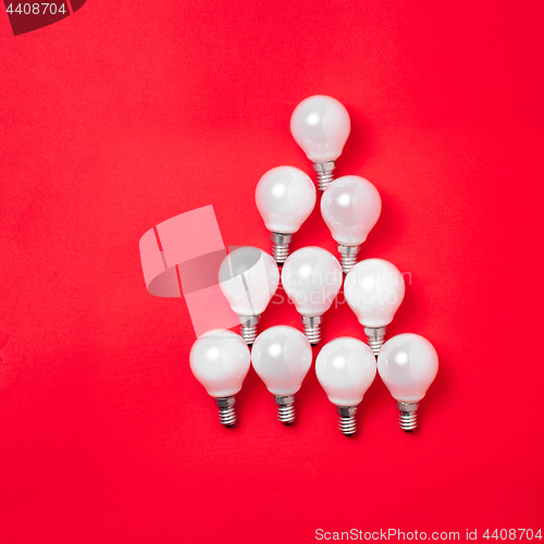 Image of The christmas tree from lantern lamps laying on red background with copy space.