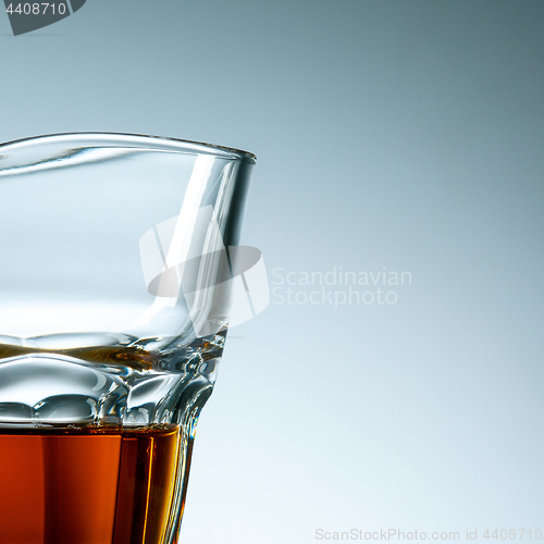 Image of The curved glass of whiskey or alcohol drink