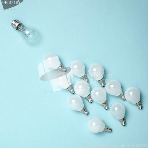 Image of One light bulb outstanding,glowing different.business creativity idea concepts.flat lay design