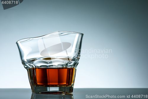 Image of The curved glass of whiskey or alcohol drink