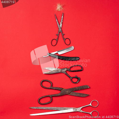 Image of combs and hairdresser tools on red background top view