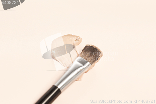 Image of Cosmetic foundation cream and powder with brush