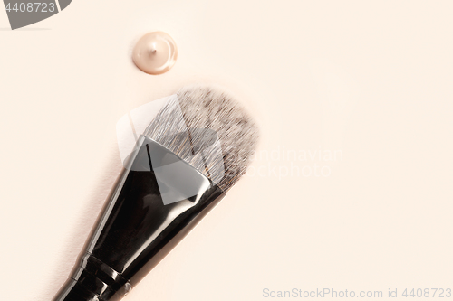 Image of Cosmetic foundation cream and powder with brush