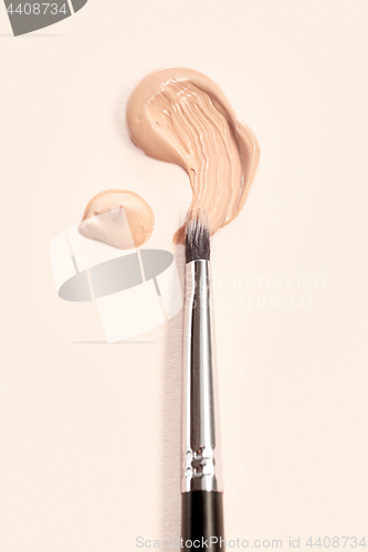 Image of Cosmetic foundation cream and powder with brush