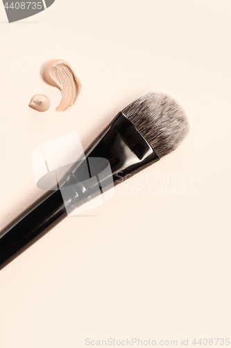 Image of Cosmetic foundation cream and powder with brush