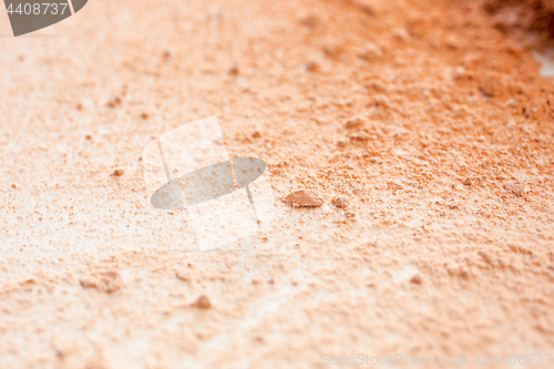 Image of Close-up of crushed mineral shimmer powder golden color with makeup brush